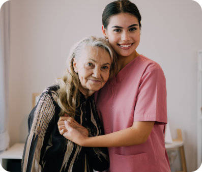nurse and elder hugging