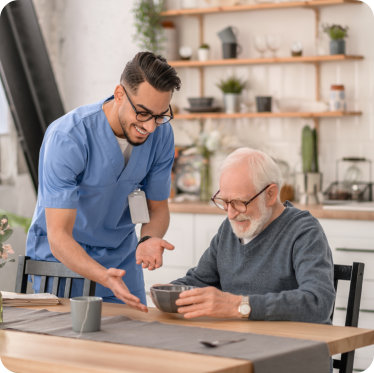 caregiver giving elder his meal