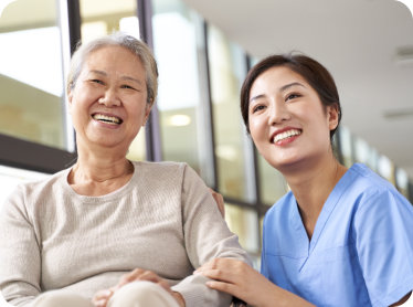 caregiver smiling with elder
