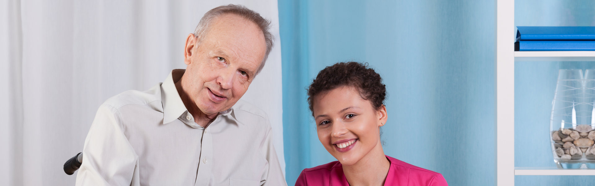 nurse beside elder and showing their lovely smiles