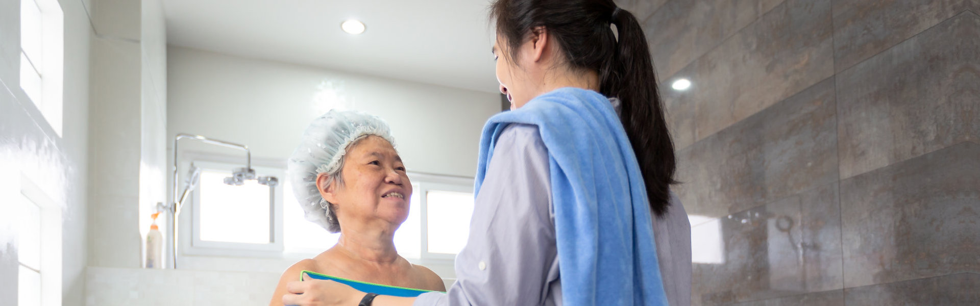 caregiver assisting elder in taking a bath