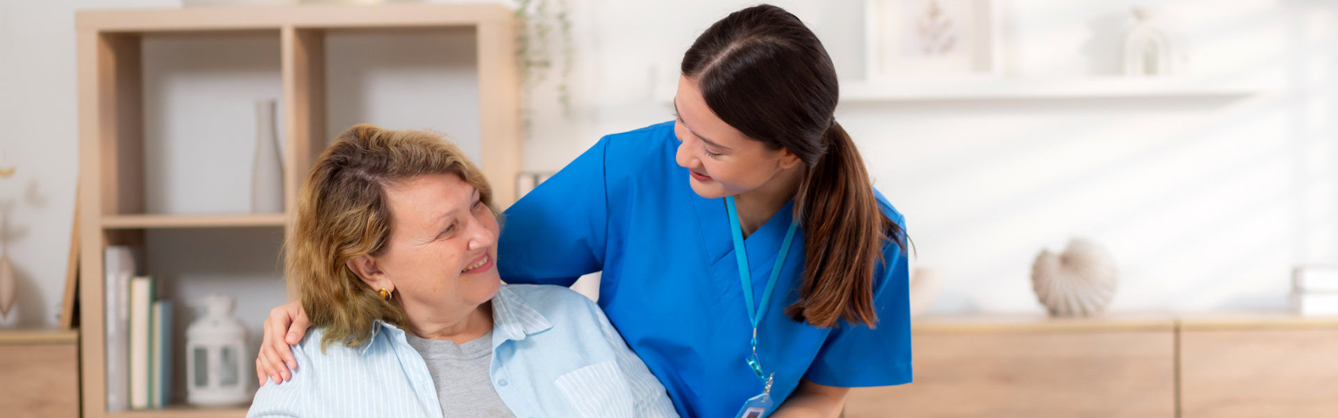 nurse looking at elder sitting in the wheelchair